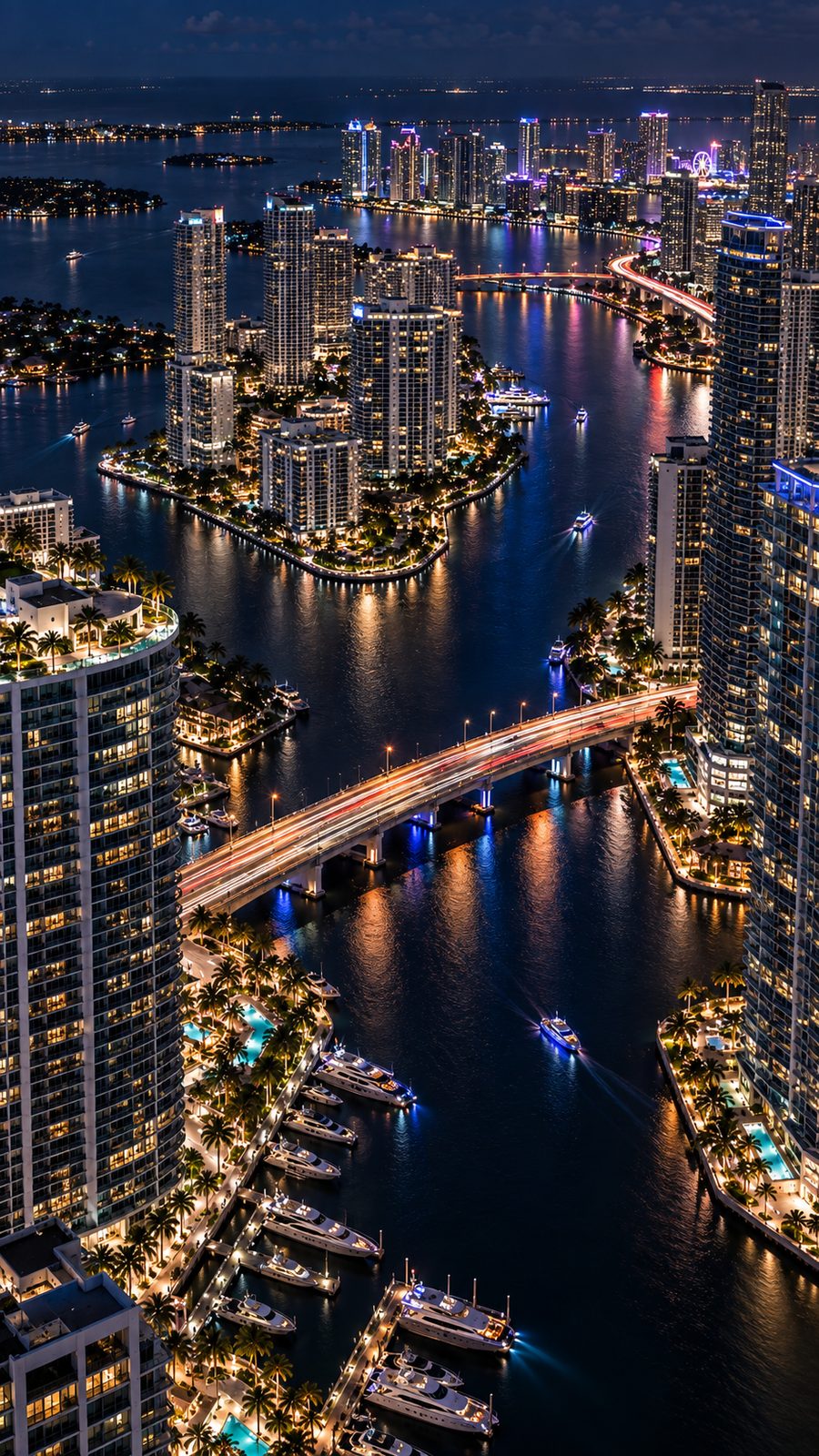 Aerial view of a city skyline and marina at night